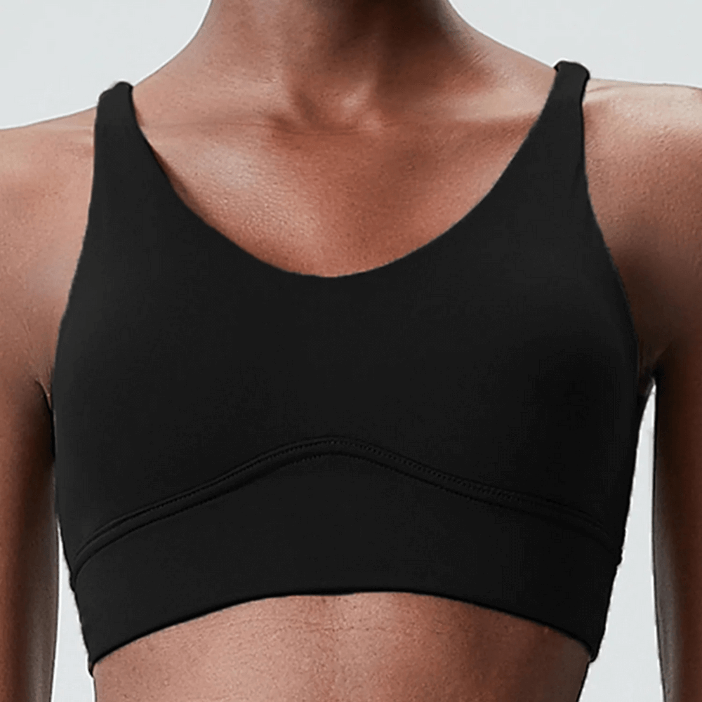 Black solid color sports bra with seamless design for ultimate comfort and support during workouts.